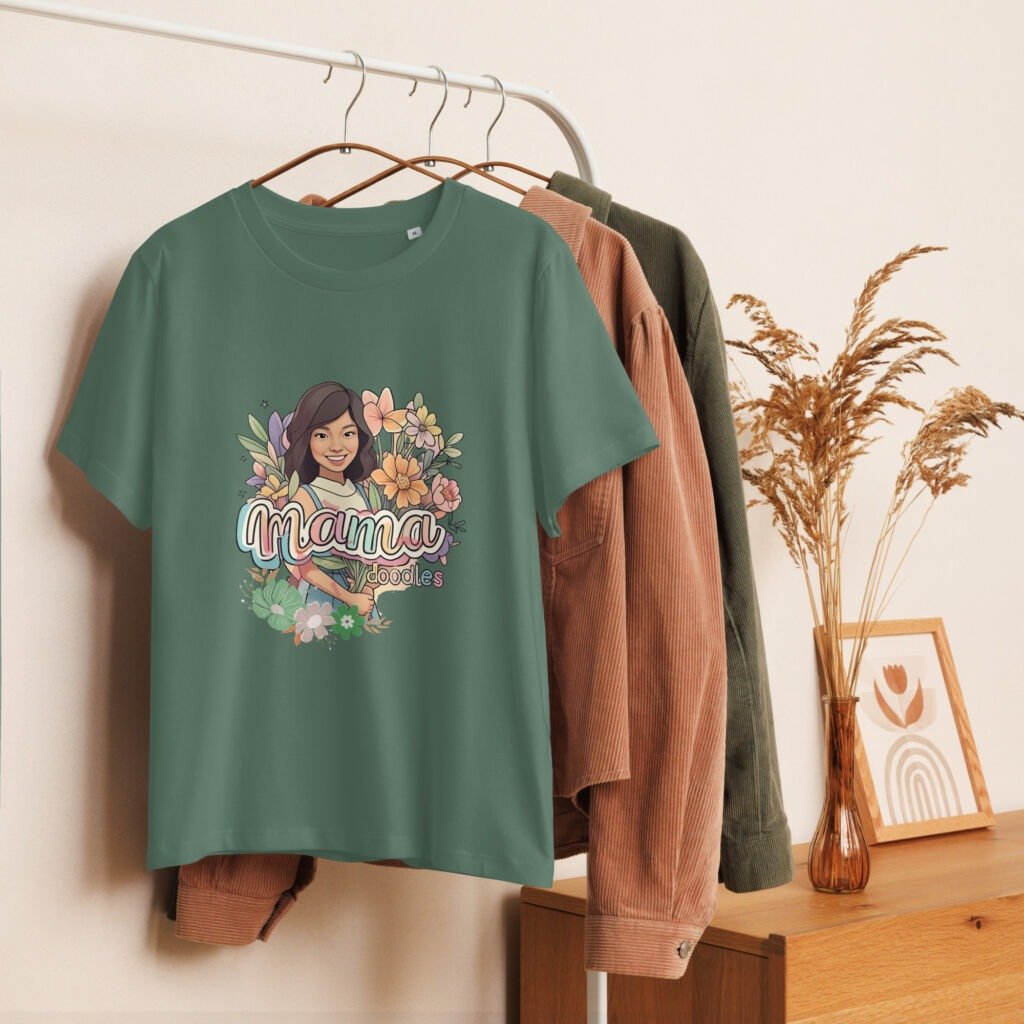 Mama graphic t-shirt for women with personalized floral design and cartoon portrait, displayed in a cozy home setup — ideal for Mother's Day gifts or custom apparel collections.